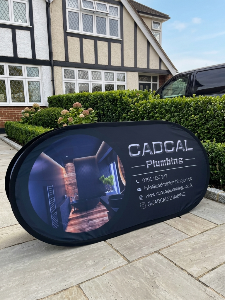 cadcal plumbing banner in front of house